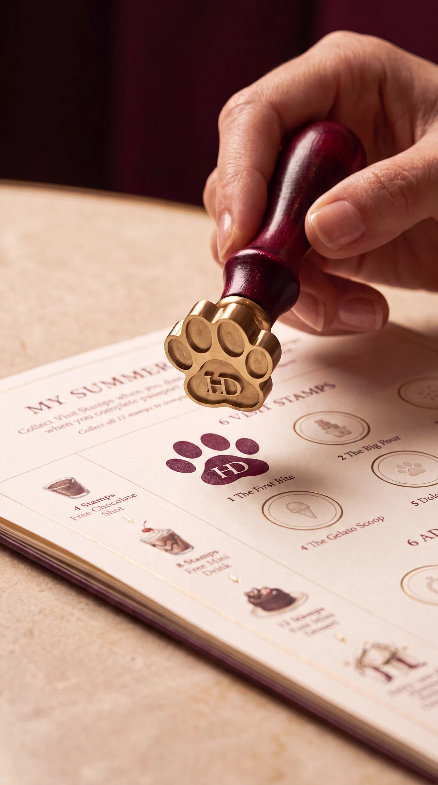 Official HD paw stamp being pressed into the Little Dolci Passport
